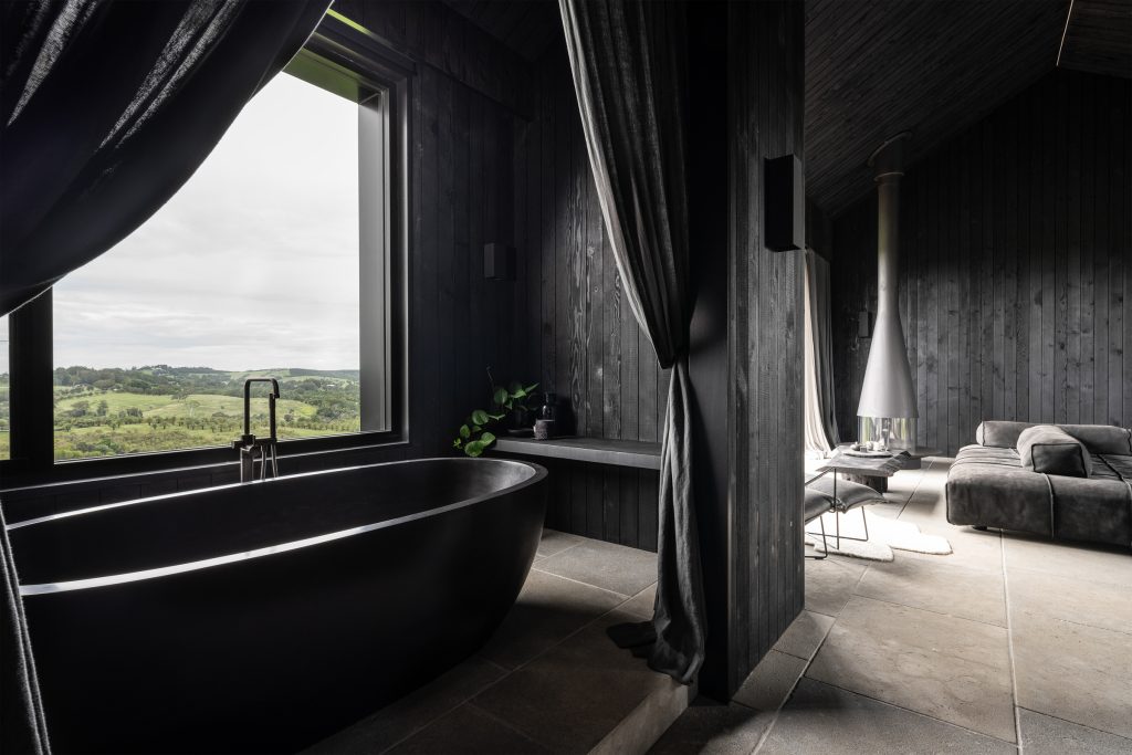Nox Byron Bay black bath and bedroom interiors looking to hinterland view