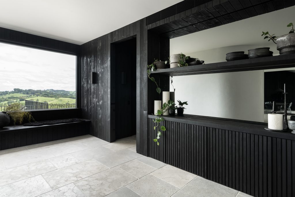 Nox Byron Bay entrance foyer with black shelving and hinterland views