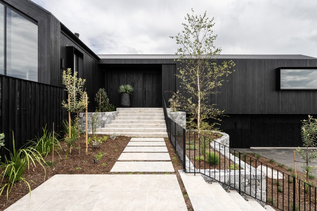 Nox Byron Bay exterior front entrance with black cladding and landscaped gardens
