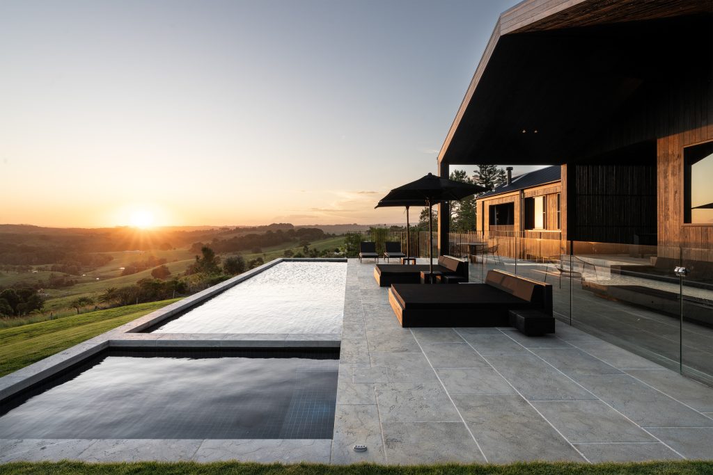 Nox Byron Bay exterior with pool looking to sunset hinterland view