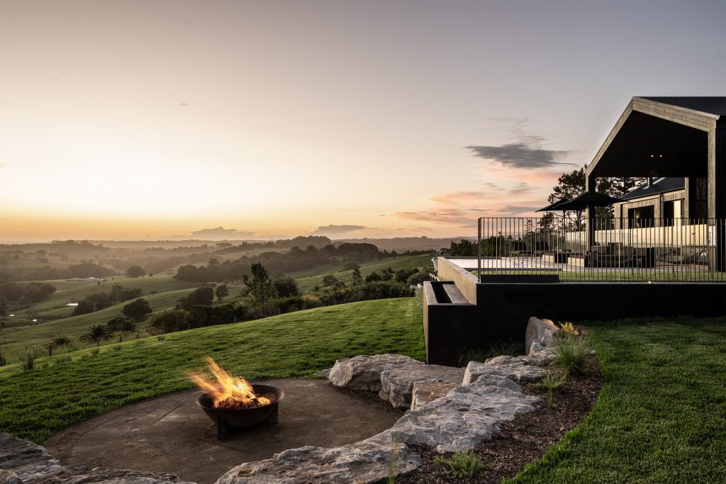 Nox Byron Bay exterior with firepit looking to hinterland views at dusk