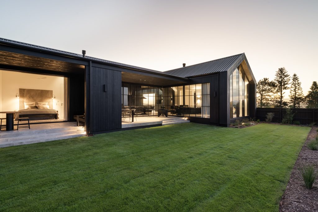 Nox Byron Bay exterior at dusk with black cladding looking to bedroom and entertaining areas