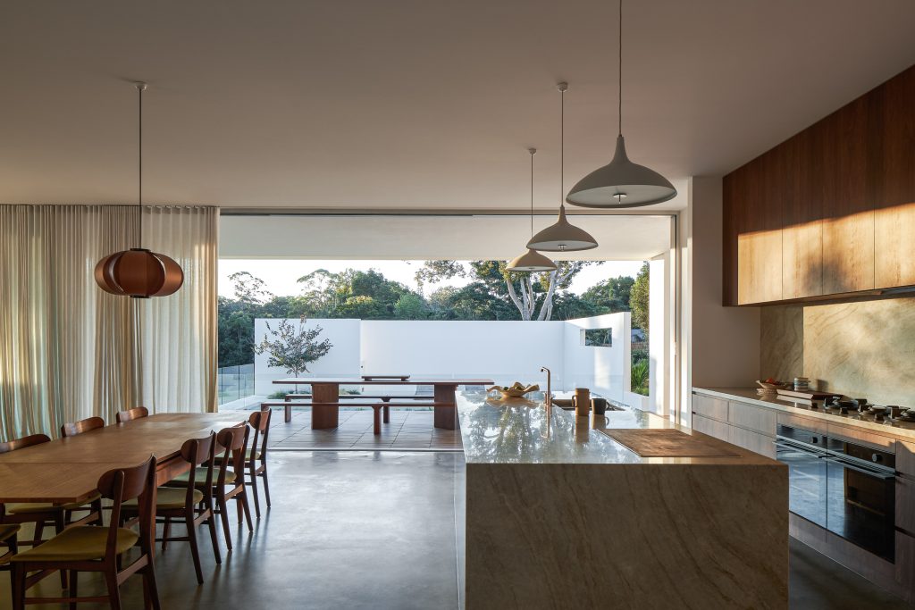 Currawong House kitchen dining leading towards outdoor deck