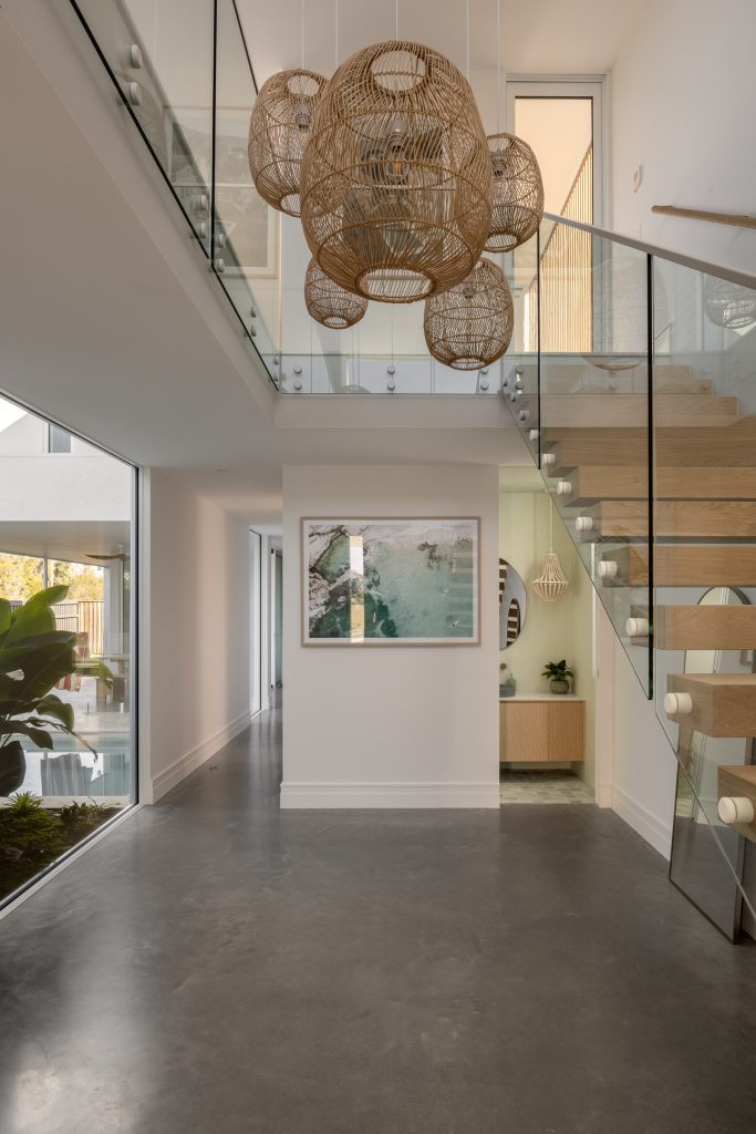 Harvest Moon entry foyer with burnished concrete floors and oak timber stairs
