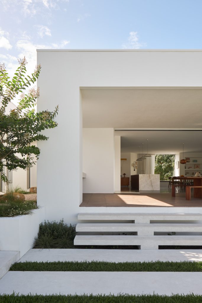 Currawong House exterior with stairs from garden to deck